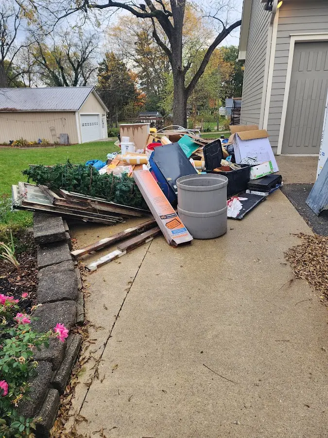Dumpster being loaded with debris for Estate Cleanout Dumpster Rental in Bangor